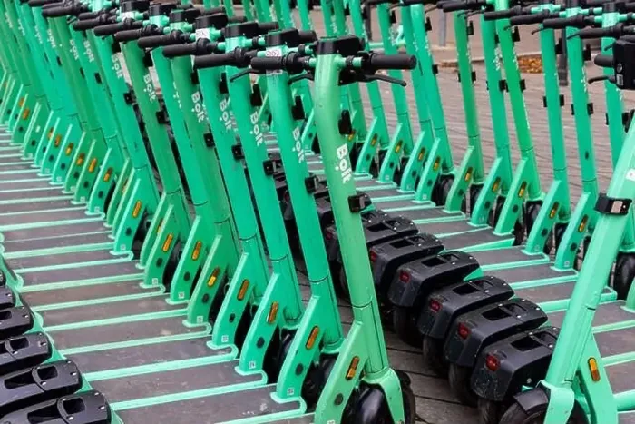 Framed Print : Rows of green electric scooters parked on a city sidewalk. Urban personal transport vehicles for rent Framed Print : Rows of green electric scooters parked on a city sidewalk. Urban personal transport vehicles for rent