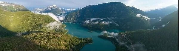 Rugged, forest-covered landscape surrounds Diablo Lake in North Cascades National Park. This mountainous region in Washington is absolutely beautiful