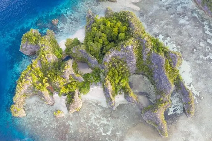 Framed Print : Rugged limestone islands rise from the serene seascape in Raja Ampat, Indonesia. This tropical region is known as the heart of the Coral Triangle Framed Print : Rugged limestone islands rise from the serene seascape in Raja Ampat, Indonesia. This tropical region is known as the heart of the Coral Triangle