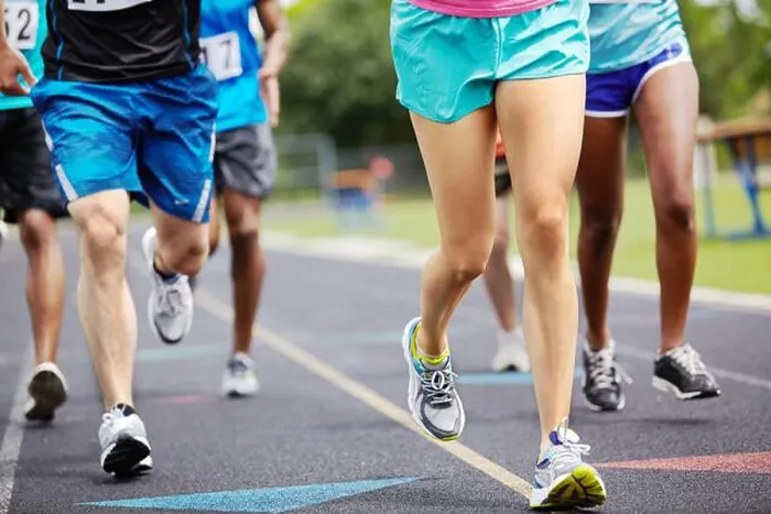 Framed Print : Running for the winning title. Cropped close up shot of athletes legs during a race