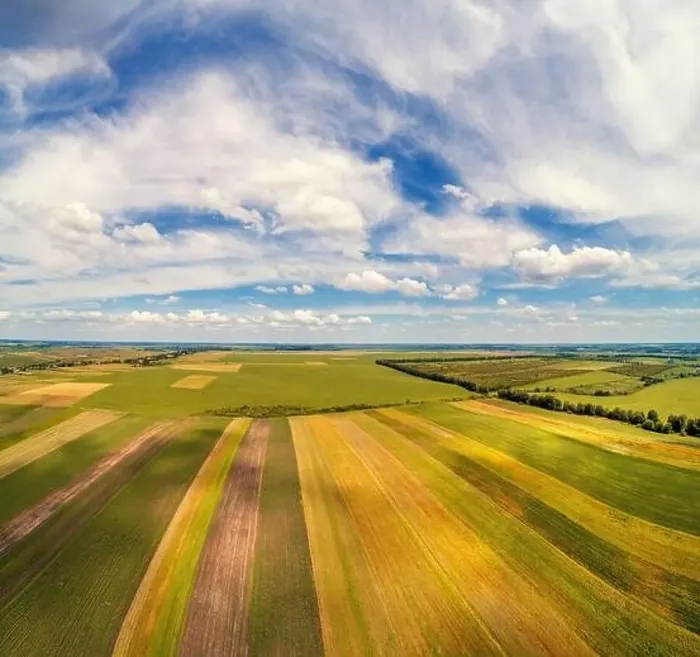 Framed Print : Rural landscape with a beautiful sky. Aerial view. View of colorful arable fields in summer Framed Print : Rural landscape with a beautiful sky. Aerial view. View of colorful arable fields in summer
