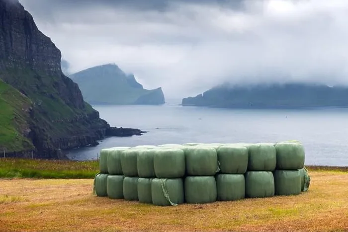 Framed Print : Rural scene with farm field and hay stacks on the Gasadalur village, Vagar island, Faroe Islands. Drangarnir and Tindholmur on background Framed Print : Rural scene with farm field and hay stacks on the Gasadalur village, Vagar island, Faroe Islands. Drangarnir and Tindholmur on background