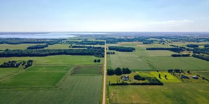 Framed Print : A rural scene of wisconsin farms during summer with lake winneconnie in the background Framed Print : A rural scene of wisconsin farms during summer with lake winneconnie in the background