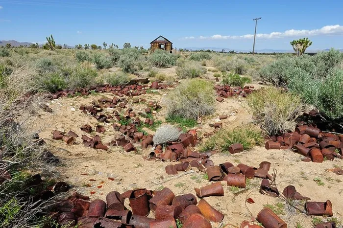 Framed Print : Rusting tin cans in the Mojave National Preserve with wooden dwelling in the distant back ground, located in Cima Framed Print : Rusting tin cans in the Mojave National Preserve with wooden dwelling in the distant back ground, located in Cima