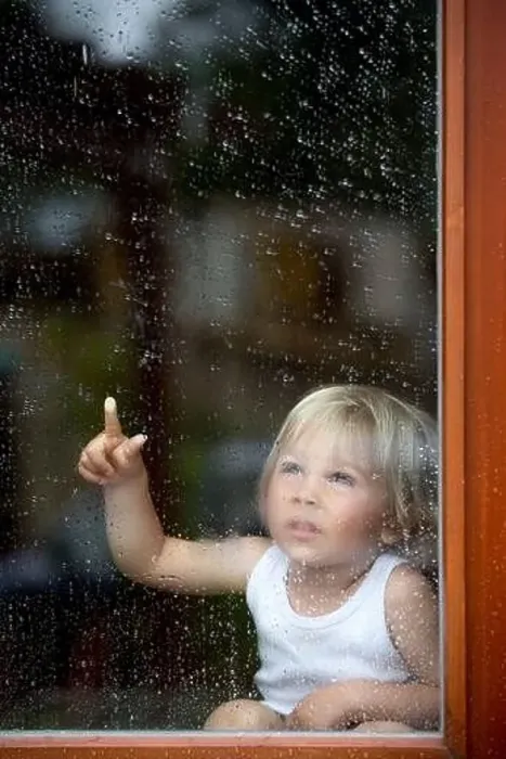Framed Print : Sad child behind the window on a rainy day Framed Print : Sad child behind the window on a rainy day