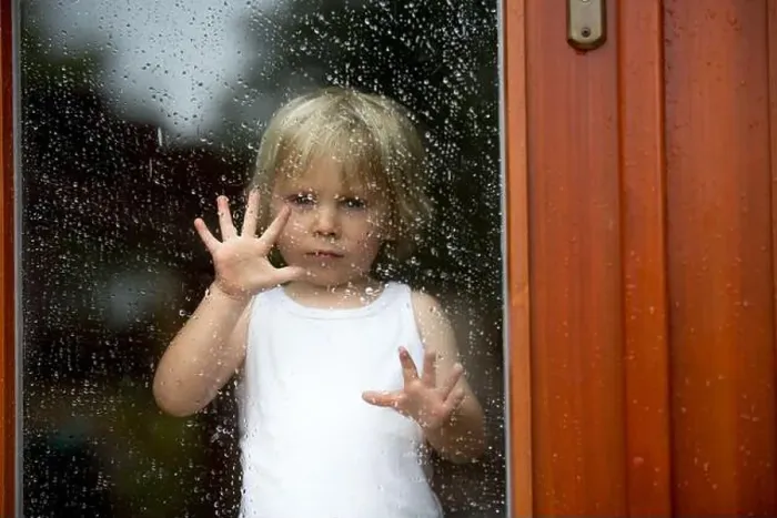 Framed Print : Sad child behind the window on a rainy day Framed Print : Sad child behind the window on a rainy day