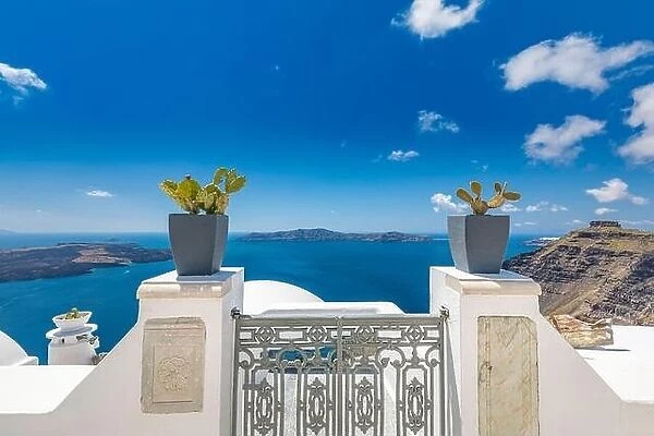 Santorini blue sea view over iron gate and flowers, white architecture and traditional Greece summer landscape. Luxurious travel vacation concept