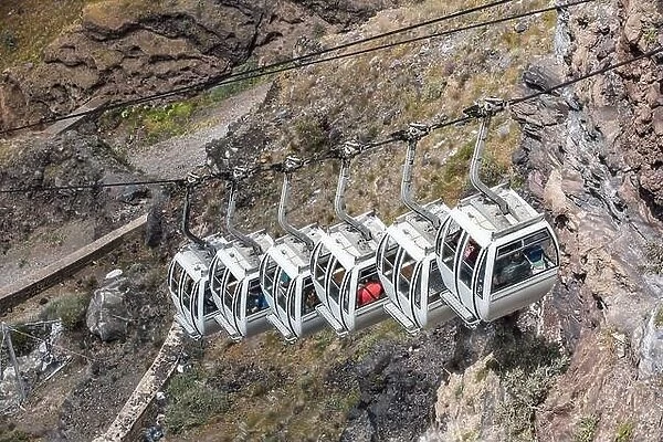 Santorini cable car, transporting tourist above the cliffs to Fira port. Summer vacation