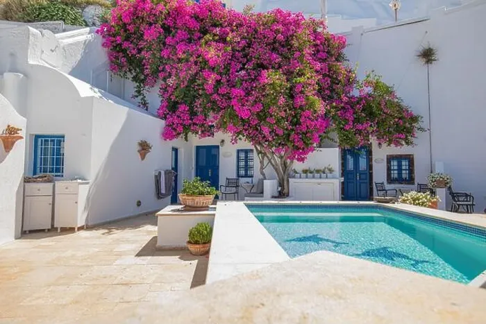 Framed Print : Santorini, Greece landscape, pool caldera view with flowers blue doors. Romantic couple destination with sunny sky, wonderful summer hotel traveling