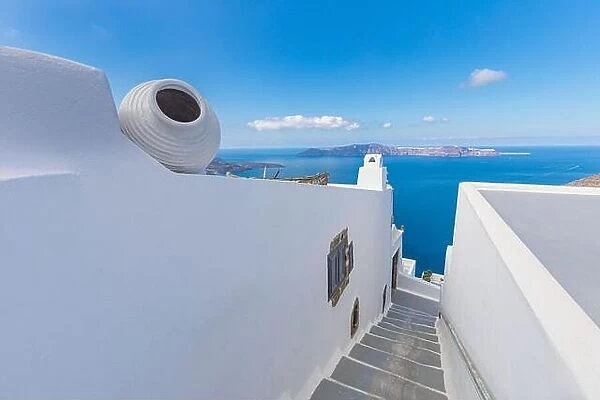 Santorini, Greece. Picturesque view of traditional cycladic Santorini houses on cliff, steps with endless sea view. Amazing travel landscape, idyllic