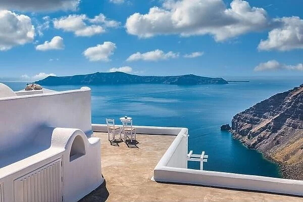 Santorini island caldera view with chairs and white architecture, romantic mood, couple travel vacation landscape destination scenic. Tourism view