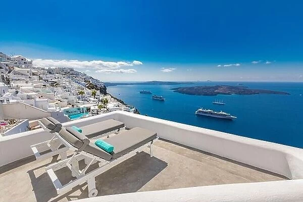 Santorini island, Greece. Travel and vacation concept, amazing summer view, white architecture blue sea view cruise ships. Lounge chairs luxury resort
