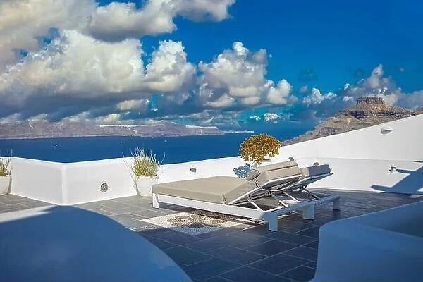 Santorini island, Oia caldera scene, two sun beds, loungers, amazing sunny sea view horizon recreational calm relax scenic. Inspirational beach resort