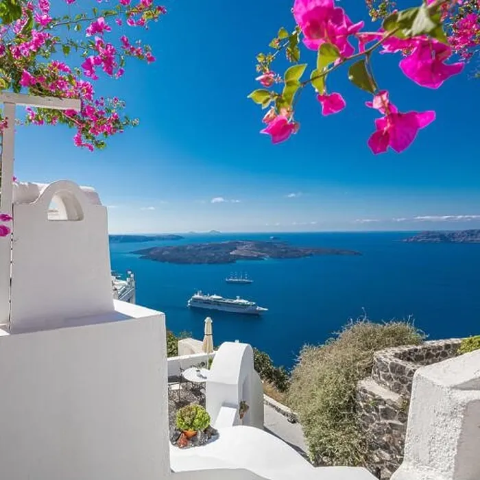 Framed Print : Santorini island, Oia, Greece. Traditional famous white architecture flowers under sunny weather over Caldera, Aegean sea. Beautiful summer vacation