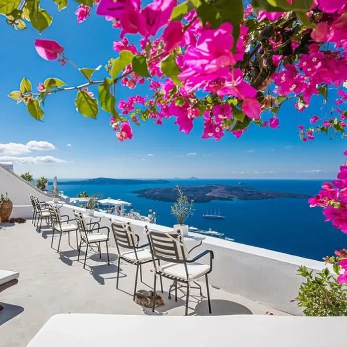 Framed Print : Santorini island, Oia, Greece. Traditional famous white architecture flowers under sunny weather over Caldera, Aegean sea. Beautiful summer vacation