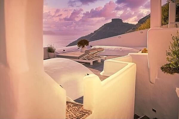 Santorini island, Oia sunset caldera scene, two sun beds, loungers, white architecture sea view colorful sky calm relax. Inspirational beach resort
