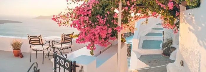 Framed Print : Santorini island sunset. Caldera view with chairs and flowers, romantic mood, couple travel vacation landscape destination scenic. Tourism romance Framed Print : Santorini island sunset. Caldera view with chairs and flowers, romantic mood, couple travel vacation landscape destination scenic. Tourism romance