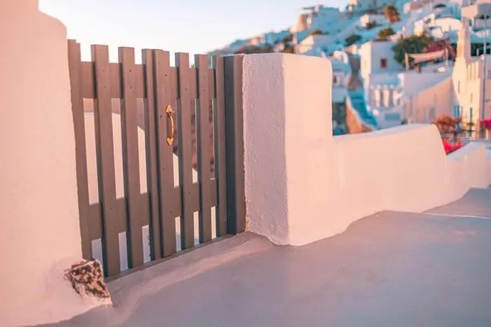 Framed Print : Santorini island sunset view. Architectural details, famous travel destination abstract closeup view of streets in warm sunset light. Wooden gate door Framed Print : Santorini island sunset view. Architectural details, famous travel destination abstract closeup view of streets in warm sunset light. Wooden gate door