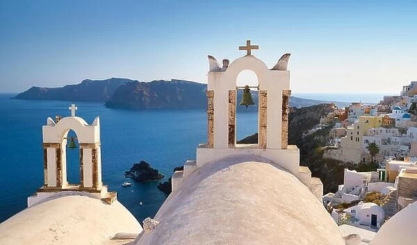 Santorini landscape with white bell tower of church and sea in the background - Oia Town, Santorini Island, Cyclades, Greece