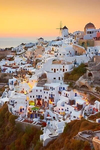 Santorini - white houses and windmills at sunset time, Oia, Greece
