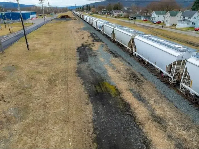 Framed Print : Sayre, PA, USA - 03-03-2024 - Cloudy winter aerial image of a bulk materials railroad car near downtown area in Framed Print : Sayre, PA, USA - 03-03-2024 - Cloudy winter aerial image of a bulk materials railroad car near downtown area in