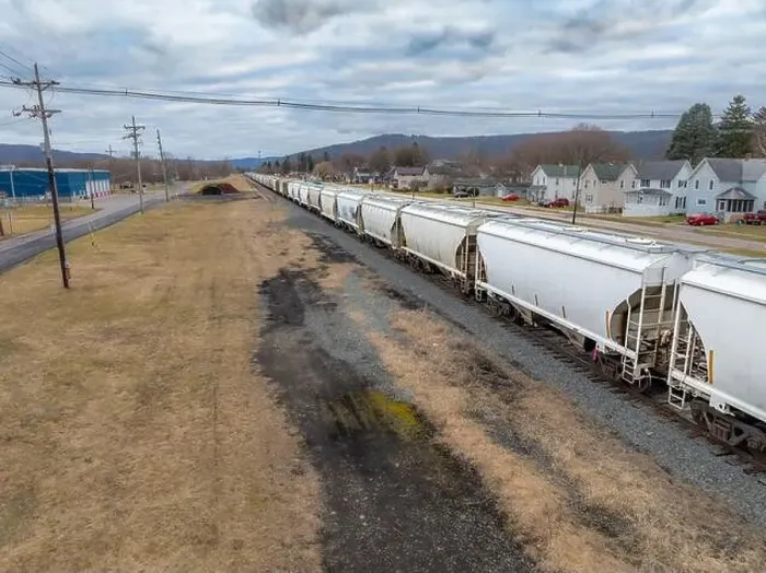 Framed Print : Sayre, PA, USA - 03-03-2024 - Cloudy winter aerial image of a bulk materials railroad car near downtown area in Framed Print : Sayre, PA, USA - 03-03-2024 - Cloudy winter aerial image of a bulk materials railroad car near downtown area in