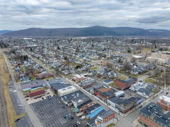 Framed Print : Sayre, PA, USA - 03-03-2024 - Cloudy winter aerial image of the downtown area in the City of Sayre, PA