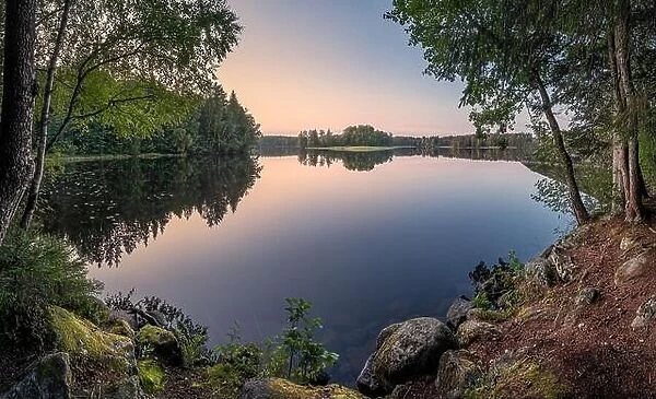 Scenic calm landscape with lake and sunset at autumn evening on Finland
