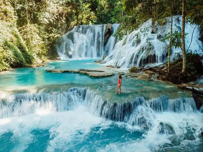 Framed Print : Scenic cascade waterfall with clear blue water and alone beauty woman in Central Sulawesi, drone view Framed Print : Scenic cascade waterfall with clear blue water and alone beauty woman in Central Sulawesi, drone view