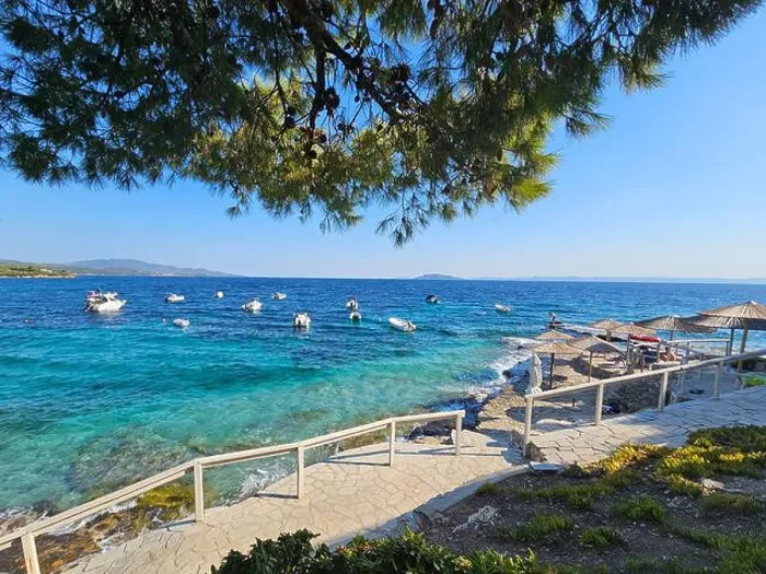 Framed Print : Scenic coastal view with boats docked in crystal clear turquoise waters in Salonic, Greece Framed Print : Scenic coastal view with boats docked in crystal clear turquoise waters in Salonic, Greece