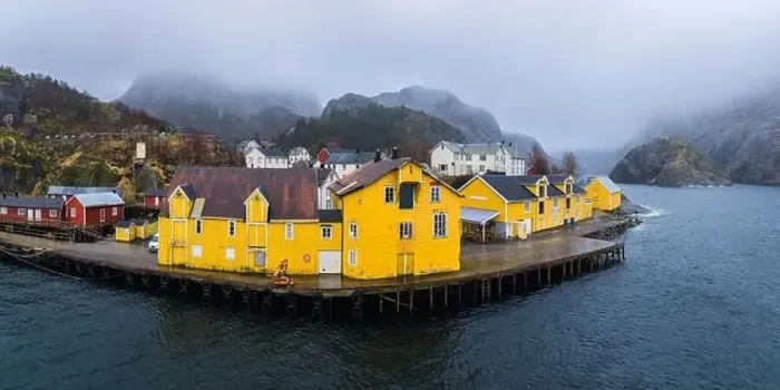 Framed Print : Scenic drone view of small settlement with typical colorful residential houses at seaside surrounded by huge rocky Framed Print : Scenic drone view of small settlement with typical colorful residential houses at seaside surrounded by huge rocky