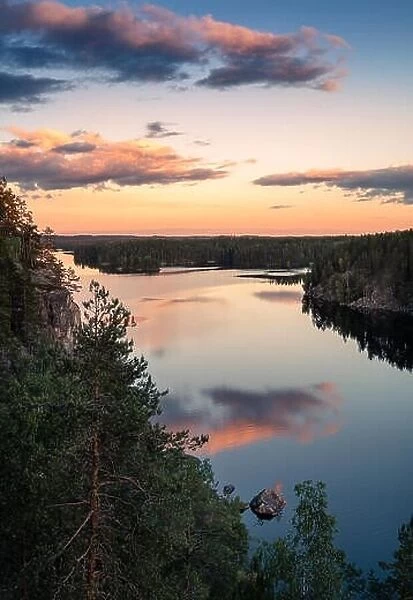 Scenic high angle view with sunrise and peaceful lake at summer evening in Finland