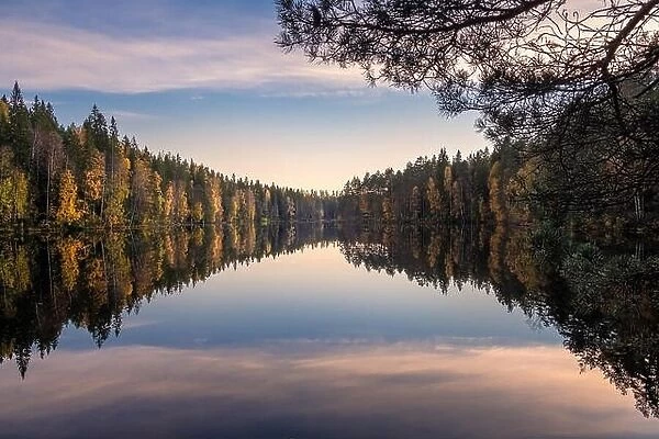 Scenic lake landscape with reflections and calm weather at autumn evening in Finland