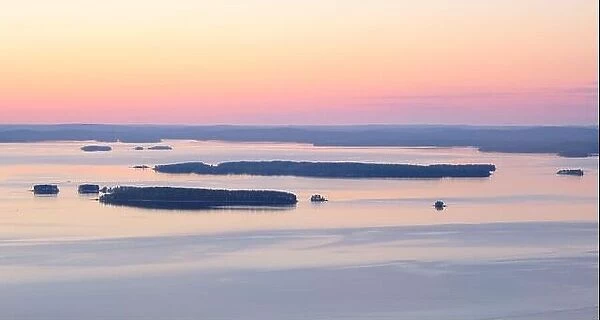 Scenic lake landscape with sunset and beautiful islands island at mood summer evening in National park Finland