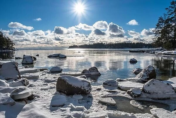 Scenic landscape with bright sun and sea at winter time