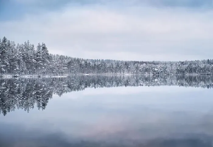 Framed Print : Scenic landscape with forest and lake at winter evening in Finland Framed Print : Scenic landscape with forest and lake at winter evening in Finland