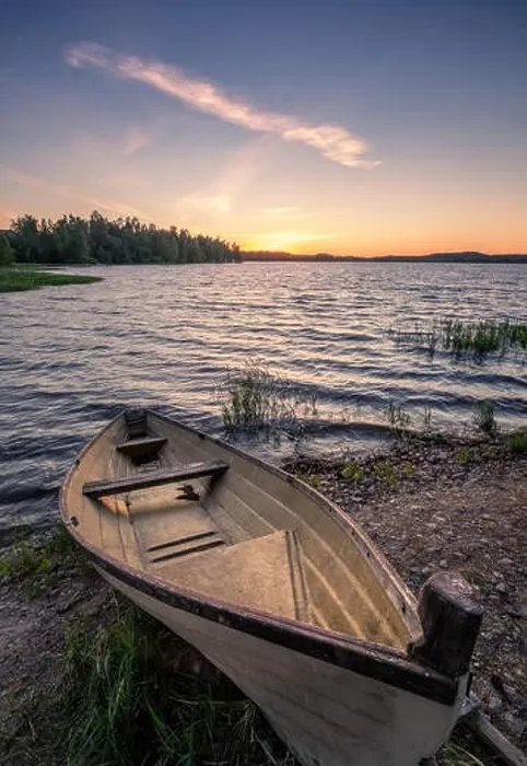 Framed Print : Scenic landscape with idyllic lake view and boat at summer evening in Finland