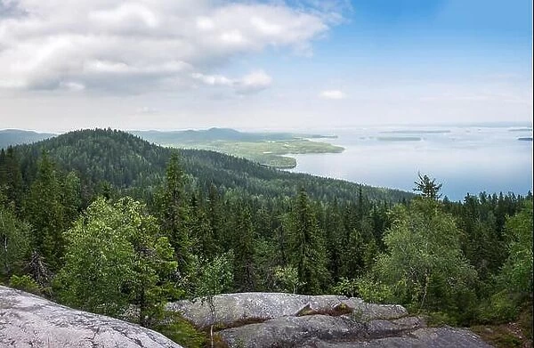 Scenic landscape with lake and lush forest at day time in Koli, national park, Finland