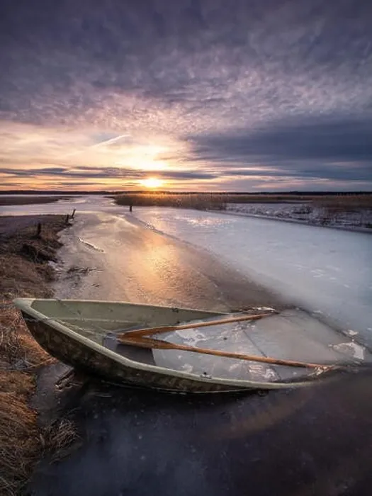 Framed Print : Scenic landscape with sunset and abandoned boat at spring evening in Finland. Boat is almoust in the ice Framed Print : Scenic landscape with sunset and abandoned boat at spring evening in Finland. Boat is almoust in the ice
