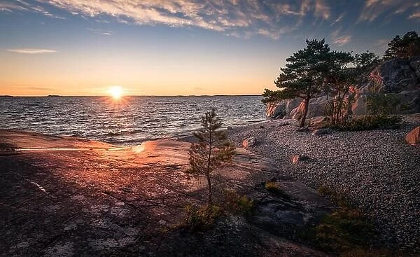 Scenic landscape with sunset and sea at summer evening in Finland