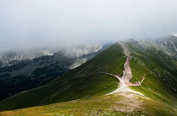 Scenic mountain view with low clouds and beautiful light at summer day in Tatra National Park, Poland
