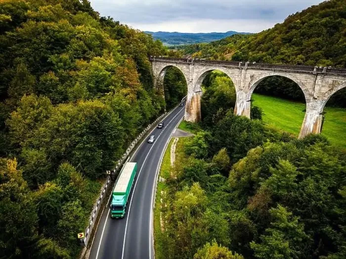 Framed Print : Scenic national road going under an old and disable train viaduct Framed Print : Scenic national road going under an old and disable train viaduct