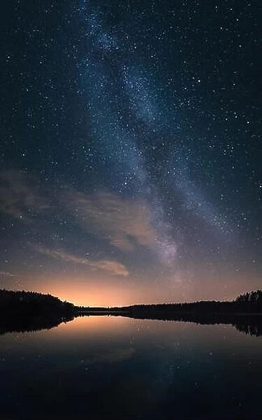 Scenic nightscape with milky way and calm lake in Finland