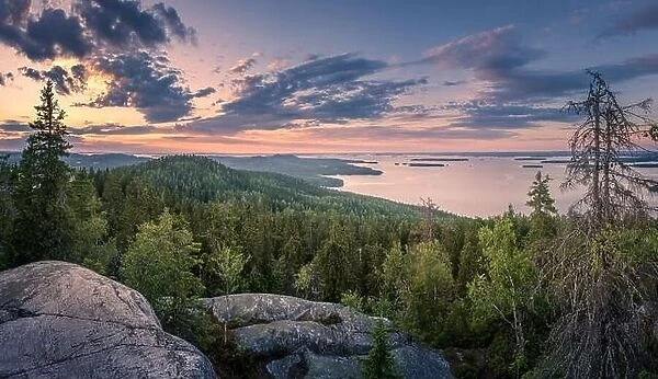 Scenic panorama landscape with lake and sunset at evening in Koli, national park, Finland