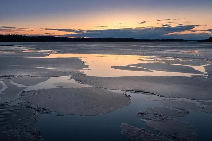 Framed Print : Scenic spring landscape with melted ice and sunset at evening light in Finland Framed Print : Scenic spring landscape with melted ice and sunset at evening light in Finland