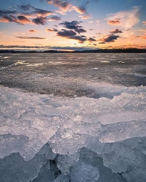 Scenic spring landscape with melting ice and sunset at evening time in Finland