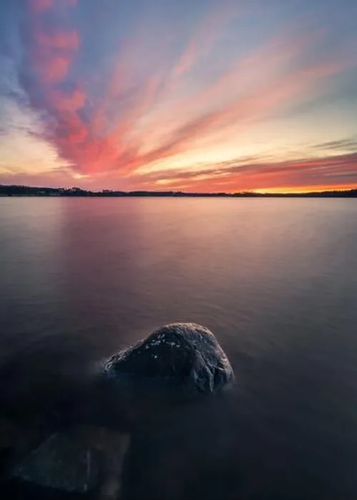 Framed Print : Scenic sunset with peaceful lake and rock at spring evening in Finland Framed Print : Scenic sunset with peaceful lake and rock at spring evening in Finland