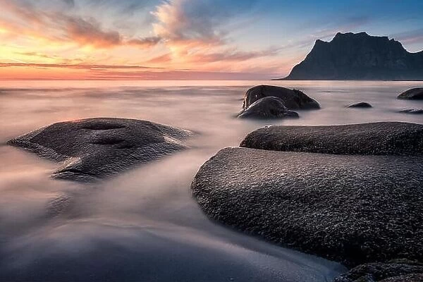 Scenic sunset with smooth water at summer night in Lofoten, Norway