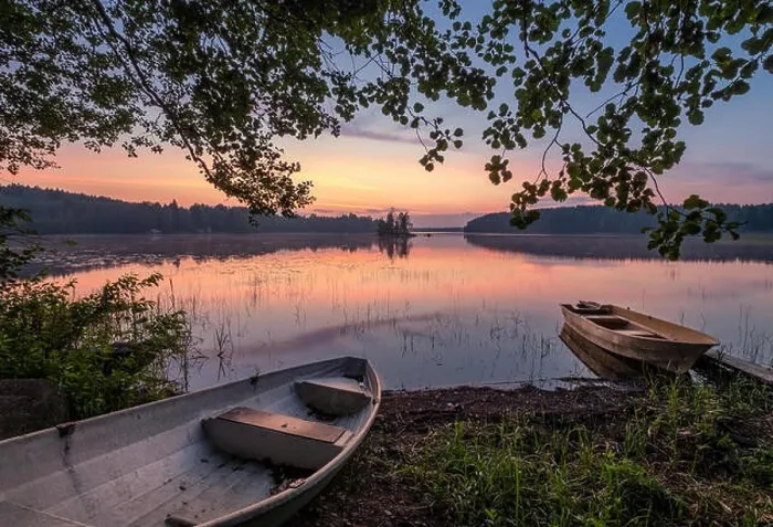 Framed Print : Scenic sunset view with two row boat and idyllic lake at summer night in Finland Framed Print : Scenic sunset view with two row boat and idyllic lake at summer night in Finland