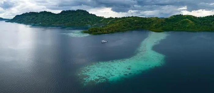 Framed Print : A scenic tropical island is fringed by a healthy coral reef in the Solomon Islands. This beautiful country is home to spectacular marine biodiversity
